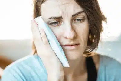 woman in black tank top holding white textile